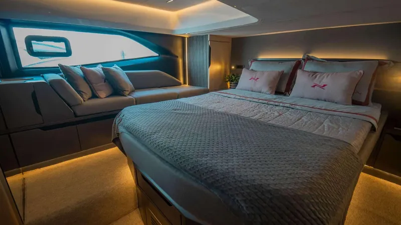 Slide: The Image of Luxurious interior of 2025 NX Boats NX44 PININFARINA, featuring elegant bedding and ambient lighting. - 16