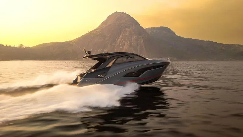 Slide: The Image of 2025 NX Boats NX44 PININFARINA cruising on water at sunset with mountain backdrop. - 4