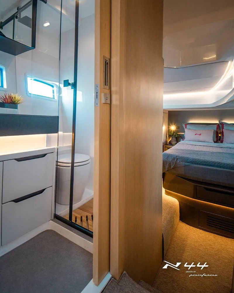 Slide: The Image of Luxurious interior of 2025 NX Boats NX44 PININFARINA, featuring modern bathroom and cozy bedroom. - 7