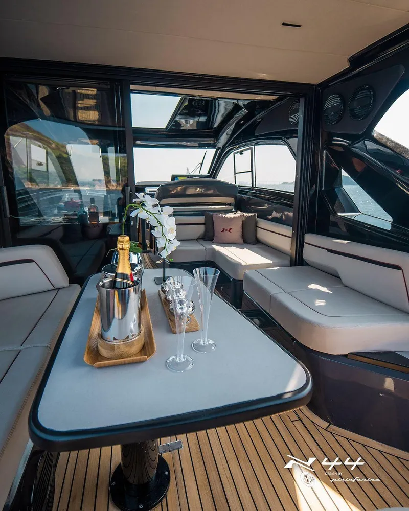 Slide: The Image of Luxurious interior of 2025 NX Boats NX44 Pininfarina yacht with elegant seating and champagne. - 8