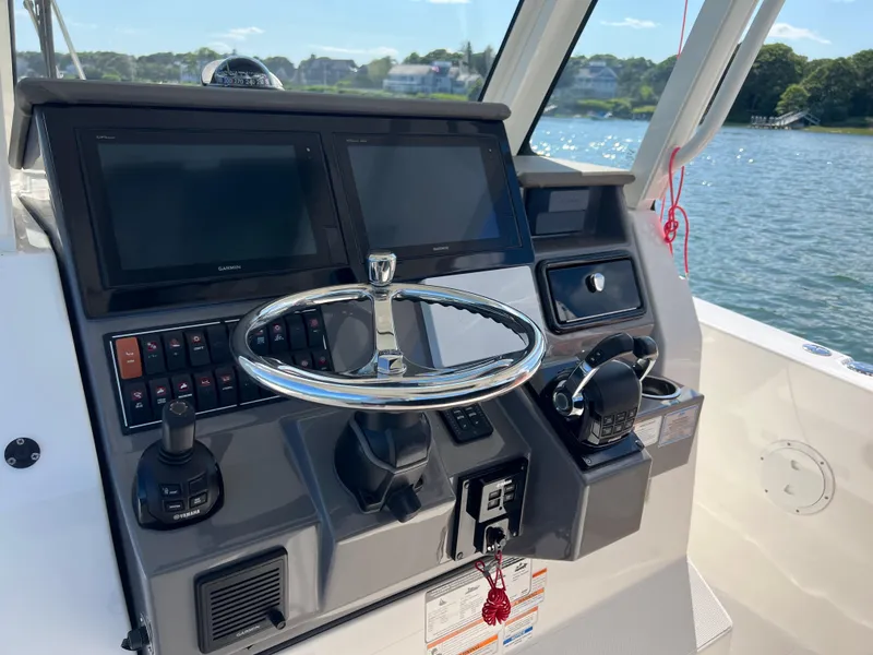 Slide: The Image of Helm of 2019 Pursuit S 288 boat with dual Garmin displays and Yamaha controls. - 10