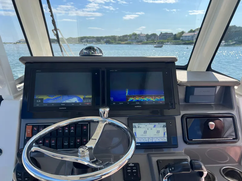Slide: The Image of Helm of 2019 Pursuit S 288 boat with Garmin navigation displays. - 11