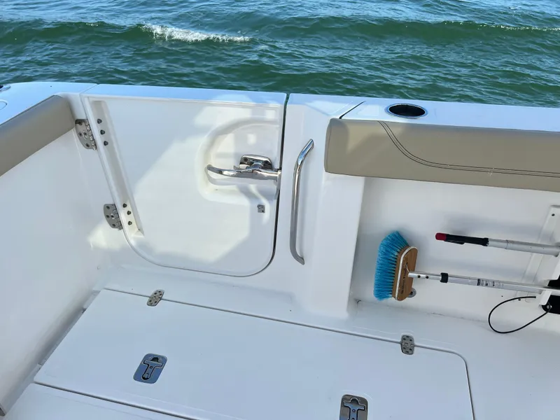 Slide: The Image of 2019 Pursuit S 288 boat deck with storage, brush, and ocean view. - 15