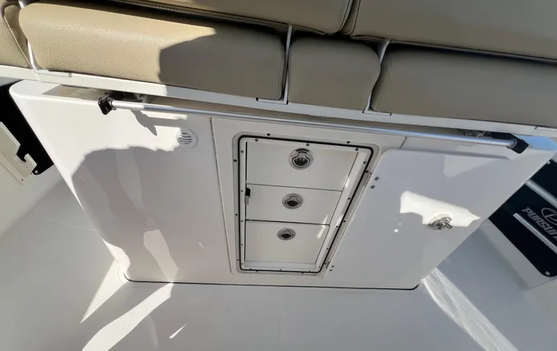 Slide: The Image of 2019 Pursuit S 288 boat interior with storage drawers and cushioned seating. - 20
