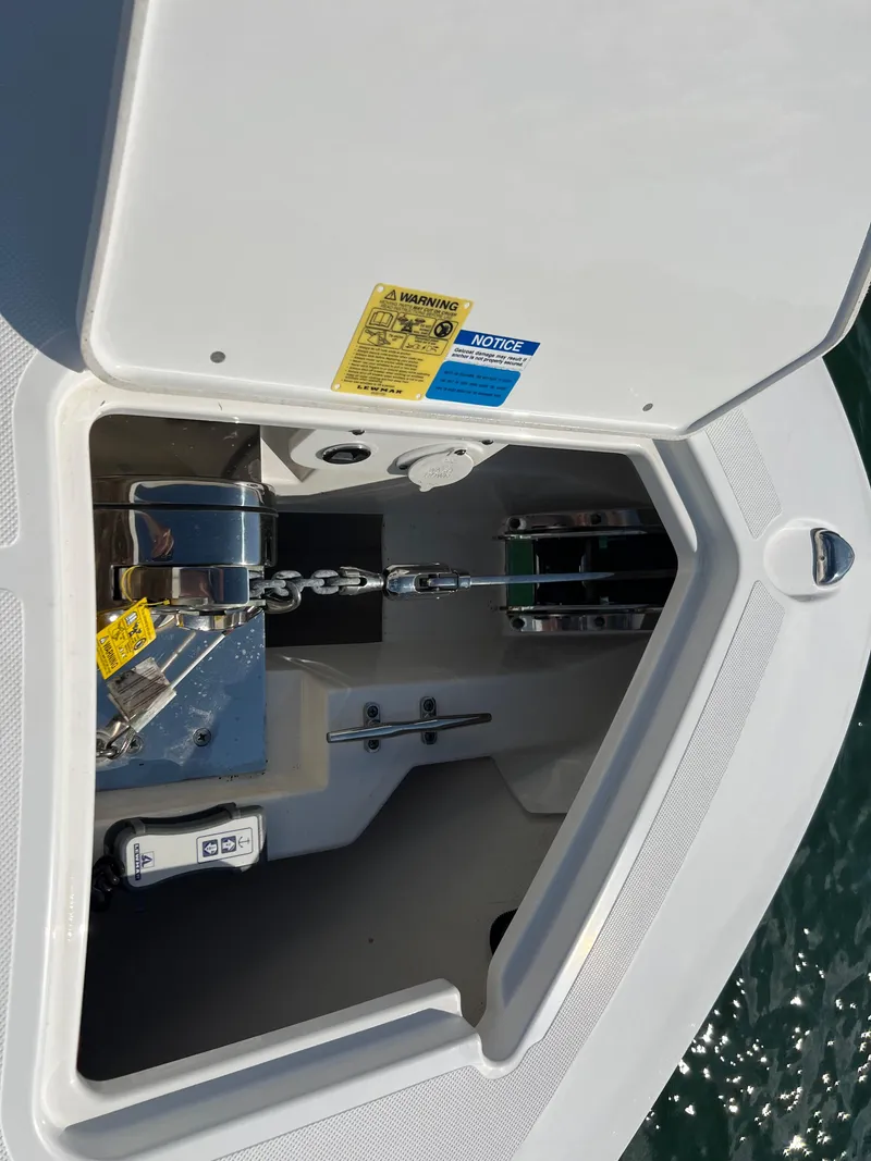 Slide: The Image of Anchor compartment of 2019 Pursuit S 288 boat with chain and winch system. - 22