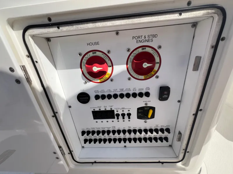 Slide: The Image of Control panel of a 2019 Pursuit S 288 boat, featuring switches and dials. - 23