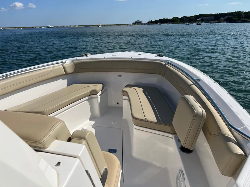 Slide: The Image of 2019 Pursuit S 288 boat with beige seating on calm water. - 3