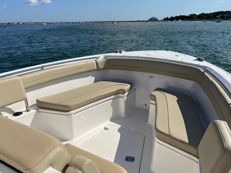 Slide: The Image of 2019 Pursuit S 288 boat interior with beige seating, on calm water. - 4