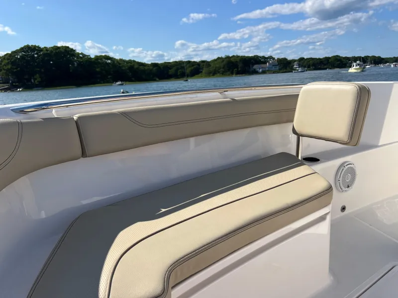 Slide: The Image of 2019 Pursuit S 288 boat interior with beige seating, scenic water view. - 5