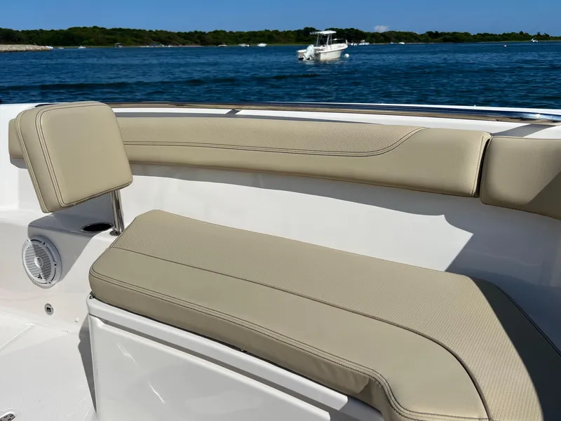 Slide: The Image of 2019 Pursuit S 288 boat interior with beige seating, ocean view in background. - 6