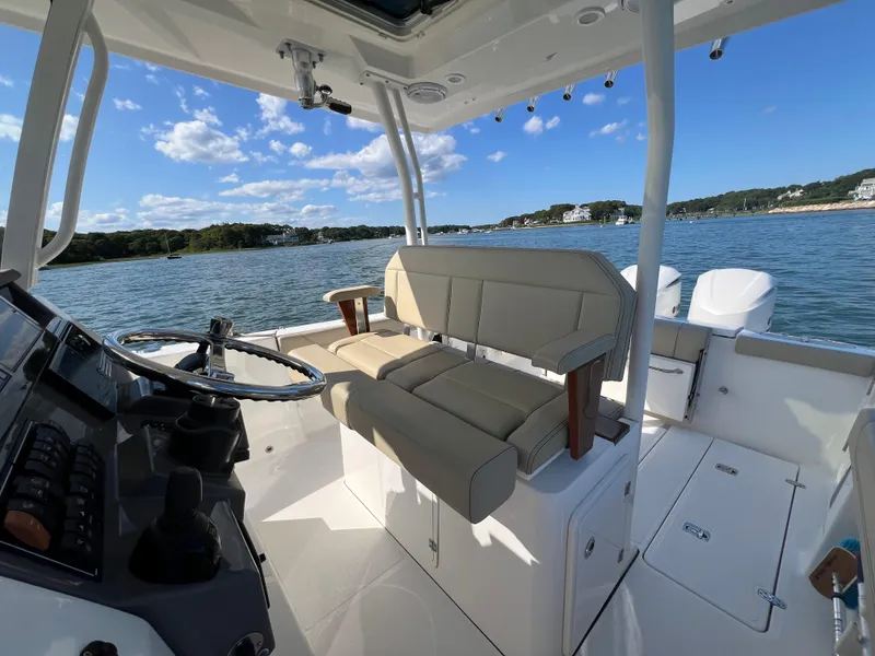 Slide: The Image of 2019 Pursuit S 288 boat interior with helm, seating, and scenic water view. - 8