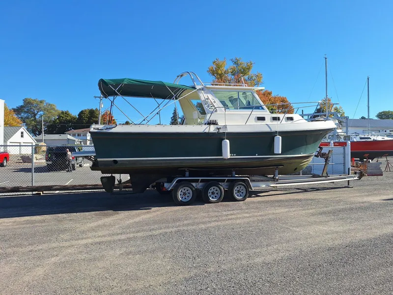 Slide: The Image of 1997 Albin 28 TE boat on trailer, parked outdoors under clear blue sky. - 27