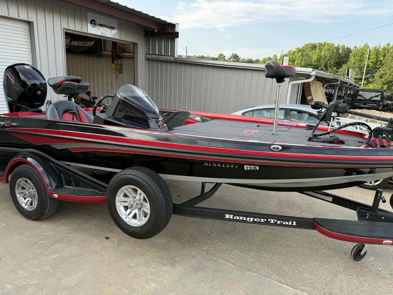 Slide: The Image of 2022 Ranger Z518 boat on trailer, parked outside a Mercury dealership. - 1