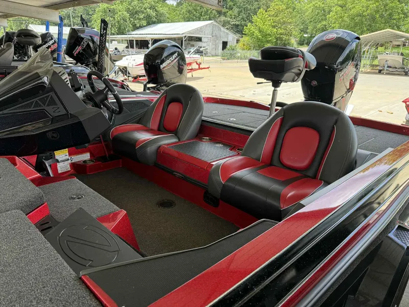 Slide: The Image of 2022 Ranger Z518 boat interior with red and black seats, dual Mercury engines. - 6