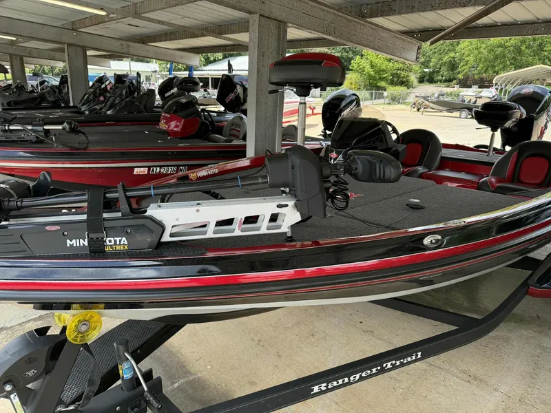 Slide: The Image of 2022 Ranger Z518 boat with Minn Kota Ultrex motor in a covered storage area. - 8