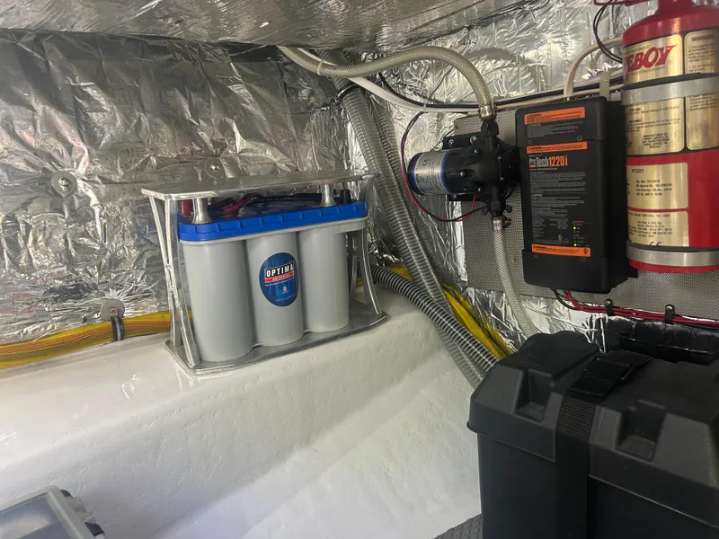 Slide: The Image of Engine compartment of a 1996 Tides 27 boat with Optima battery and fire extinguisher. - 10
