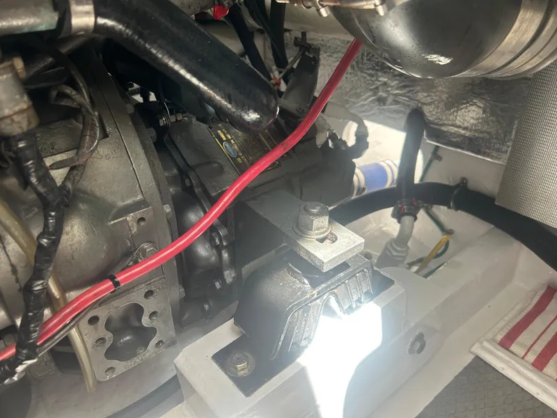 Slide: The Image of Engine compartment of a 1996 Tides 27 boat, featuring mechanical components and wiring. - 14