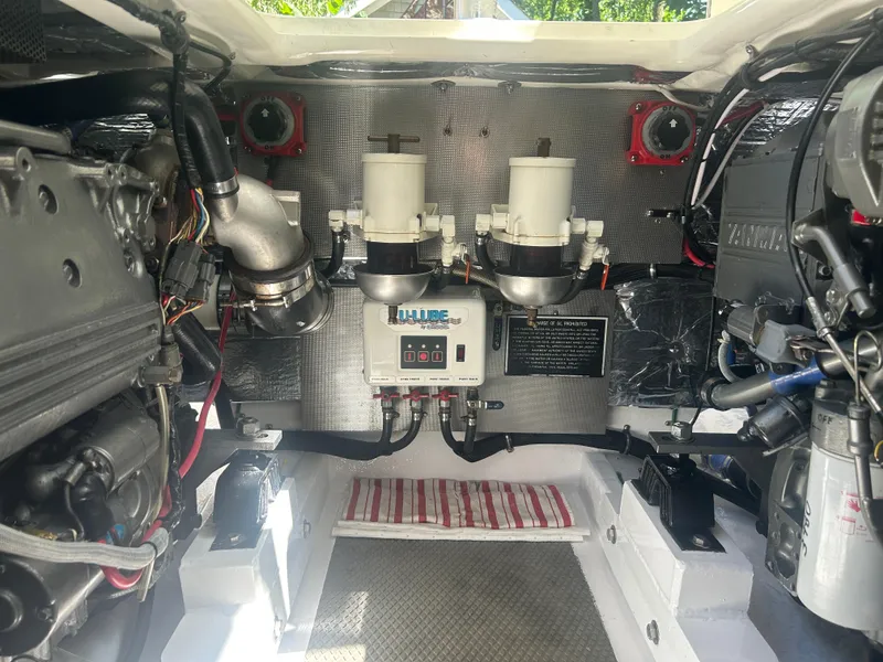 Slide: The Image of Engine compartment of a 1996 Tides 27 boat, showcasing mechanical components and wiring. - 17