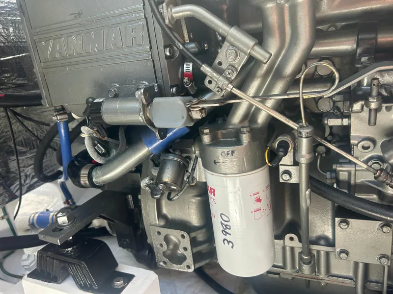 Slide: The Image of Close-up of a Yanmar engine in a 1996 Tides 27 boat, showing detailed components. - 18