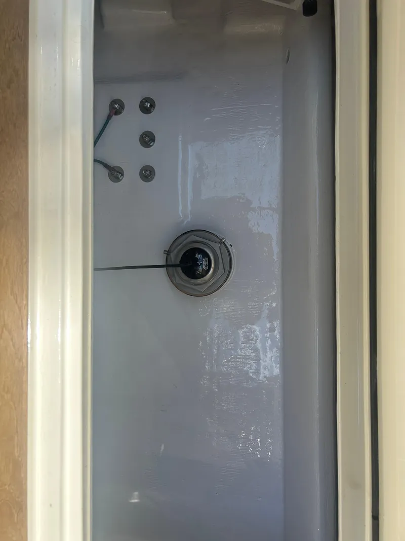 Slide: The Image of Interior view of a 1996 Tides 27 boat compartment with visible controls and wiring. - 20