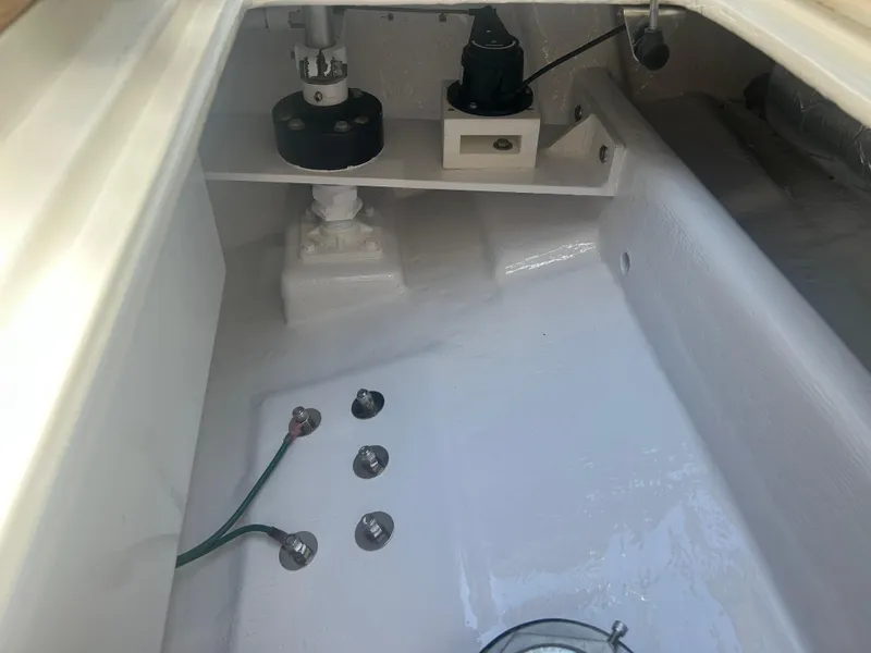 Slide: The Image of Interior view of a 1996 Tides 27 boat showing mechanical components and wiring. - 21