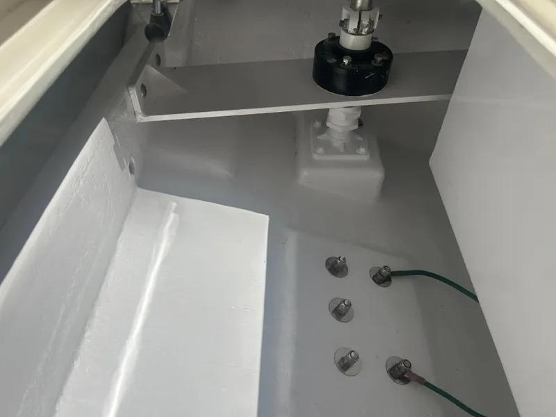 Slide: The Image of Interior view of a 1996 Tides 27 boat, showcasing mechanical components and wiring. - 22