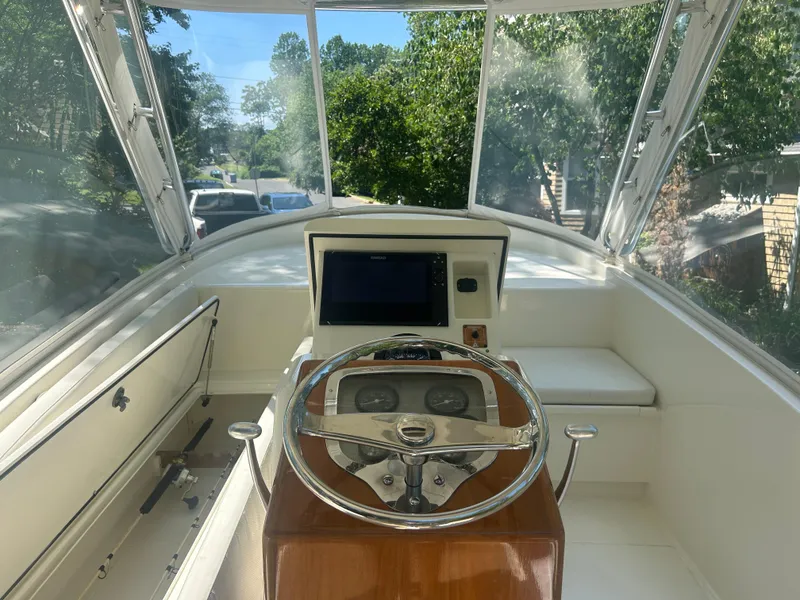 Slide: The Image of Interior view of a 1996 Tides 27 boat cockpit with steering wheel and navigation equipment. - 23