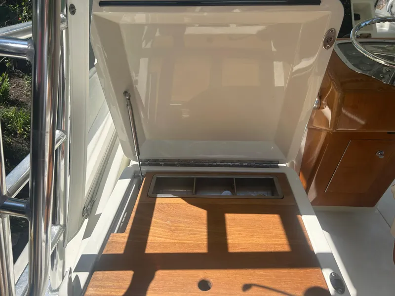 Slide: The Image of Open hatch on 1996 Tides 27 boat, revealing storage compartment. - 25
