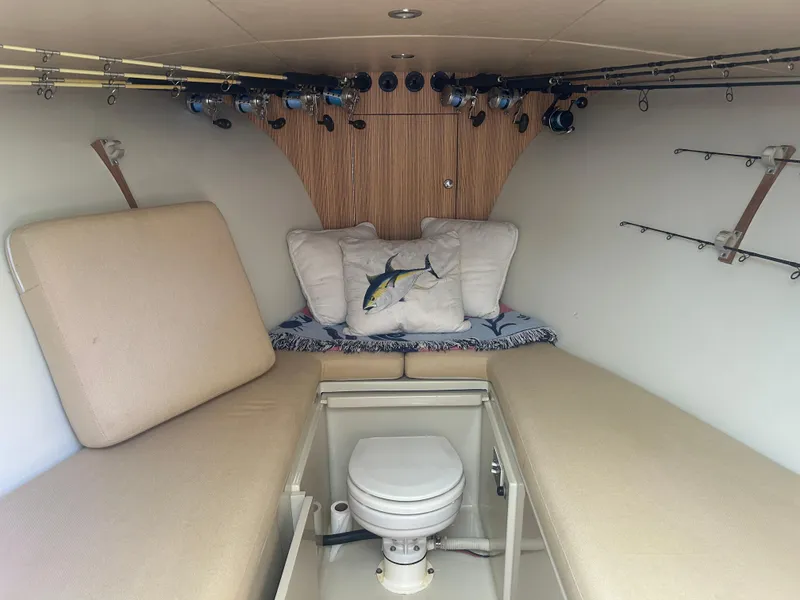 Slide: The Image of Cozy cabin interior of a 1996 Tides 27 boat with fishing rods and cushions. - 27