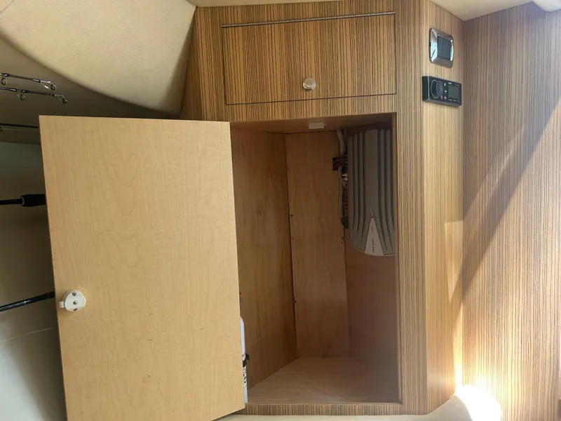Slide: The Image of Interior of a 1996 Tides 27 boat showing wooden cabinetry and storage space. - 28