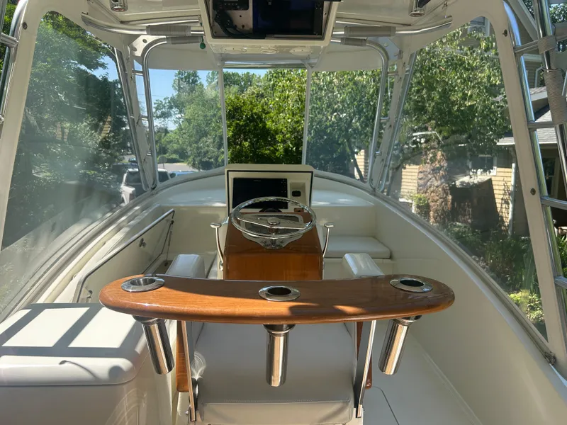 Slide: The Image of Interior view of a 1996 Tides 27 boat, featuring a sleek helm and seating area. - 5