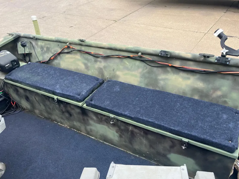 Slide: The Image of Interior of a 2012 Steven Custom JON EXTRA WIDE boat with cushioned seating. - 10