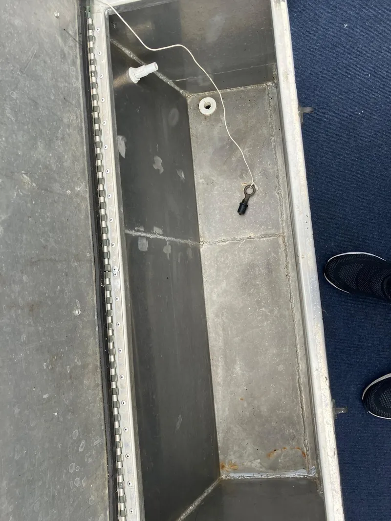 Slide: The Image of Open storage compartment in a 2012 Steven Custom JON EXTRA WIDE boat. - 14