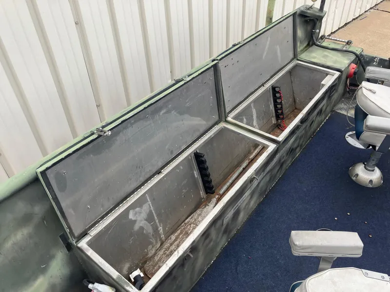 Slide: The Image of 2012 Steven Custom JON EXTRA WIDE boat interior with storage compartments and seating. - 15