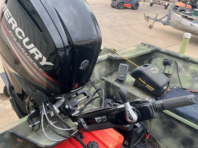 Slide: The Image of Boat with Mercury FourStroke engine, Steven Custom JON EXTRA WIDE 2012 model, featuring control panel and equipment. - 16