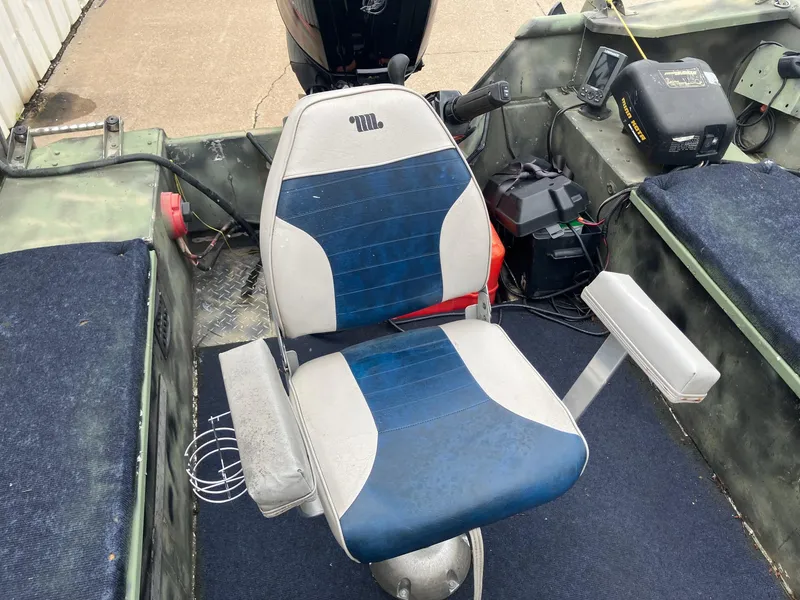 Slide: The Image of Boat interior with a blue and white swivel seat, featuring a Steven Custom JON EXTRA WIDE model, 2012. - 22