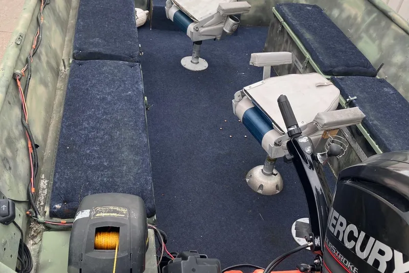 Slide: The Image of Interior of a 2012 Steven Custom JON EXTRA WIDE boat with seating and Mercury motor. - 31