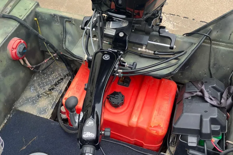 Slide: The Image of Boat interior with motor controls, red fuel tank, and wiring, Steven Custom JON EXTRA WIDE 2012 model. - 34