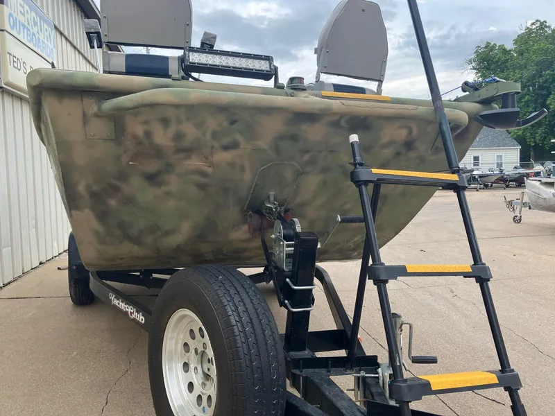 Slide: The Image of 2012 Steven Custom JON EXTRA WIDE boat on trailer with camouflage design and ladder. - 5