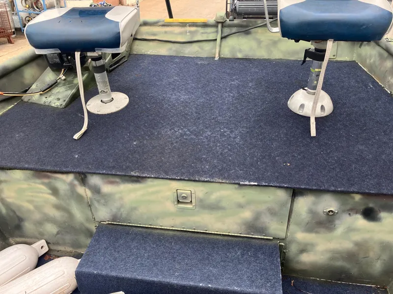 Slide: The Image of Two blue boat seats on a carpeted deck of a 2012 Steven Custom JON EXTRA WIDE. - 8