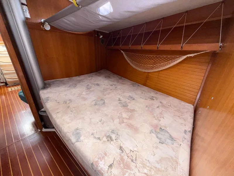 Slide: The Image of Cozy cabin interior of 1998 Catalina 42Mk 2 sailboat with wooden paneling and bed. - 15
