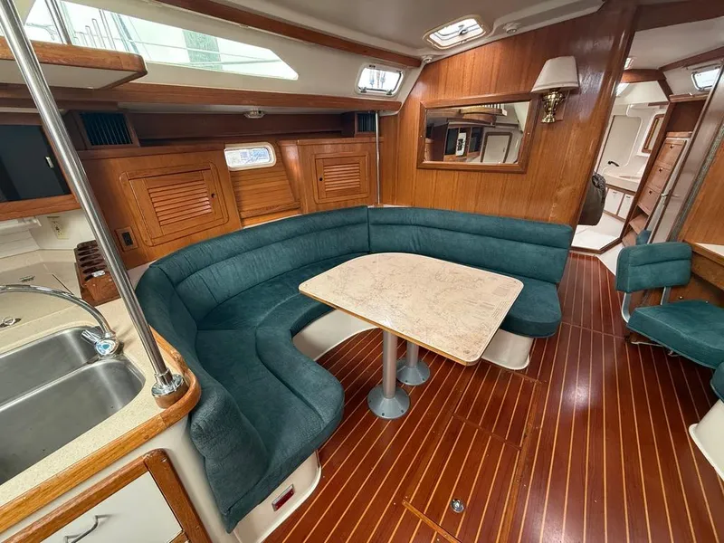 Slide: The Image of Interior of 1998 Catalina 42Mk 2 yacht with wood finish and green seating. - 3