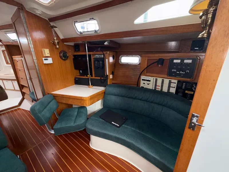 Slide: The Image of Interior of 1998 Catalina 42Mk 2 sailboat with wood paneling and green seating. - 9