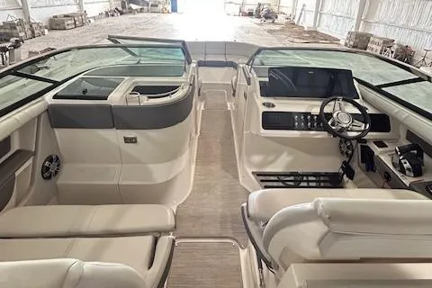 Slide: The Image of 2021 Sea Ray SLX 310 boat interior with modern dashboard and seating. - 10