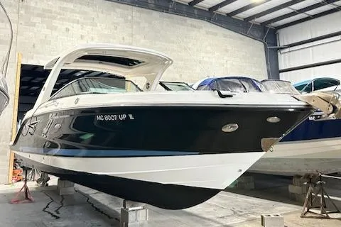 Slide: The Image of 2021 Sea Ray SLX 310 boat in storage, showcasing sleek design and modern features. - 4