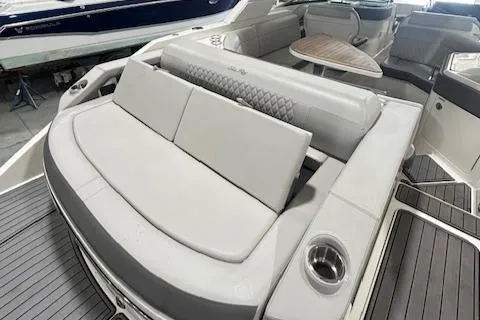 Slide: The Image of 2021 Sea Ray SLX 310 boat interior with luxurious seating and table. - 5