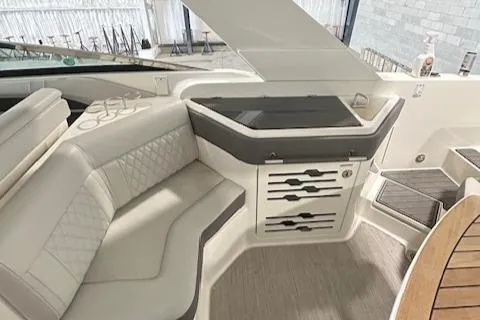 Slide: The Image of 2021 Sea Ray SLX 310 boat interior with elegant seating and storage area. - 9