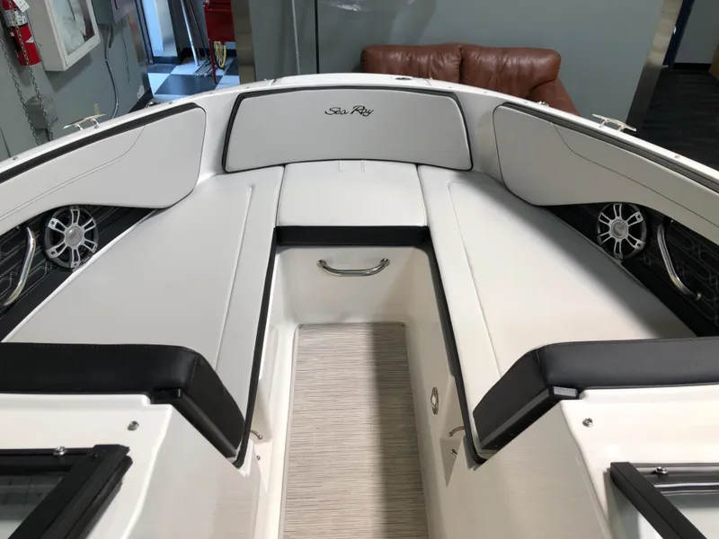 Slide: The Image of 2025 Sea Ray SPX 210 boat interior with cushioned seating and modern design. - 10