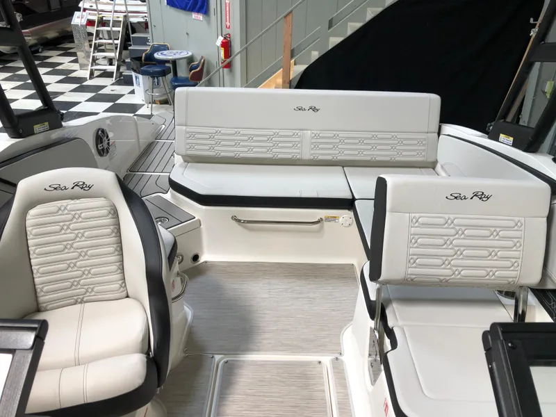 Slide: The Image of 2025 Sea Ray SPX 210 boat interior with white seating and modern design. - 11