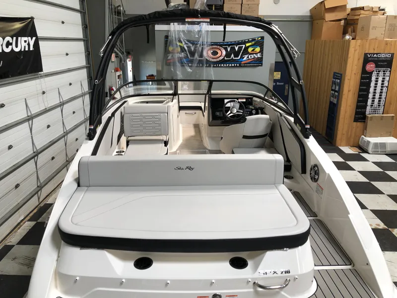 Slide: The Image of 2025 Sea Ray SPX 210 boat interior in showroom, featuring sleek design and modern amenities. - 4